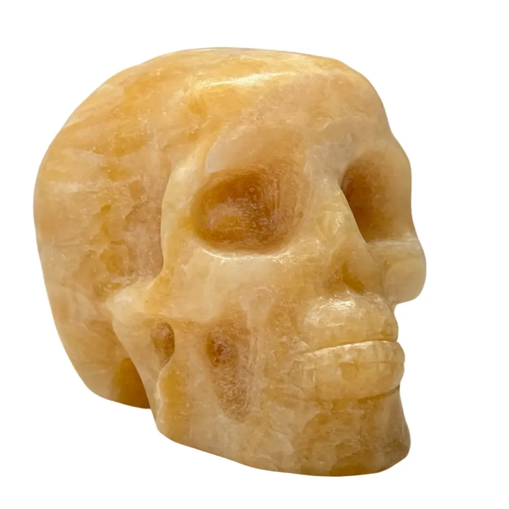 Gepolijste en geslepen schedel van oranje calciet 9 cm